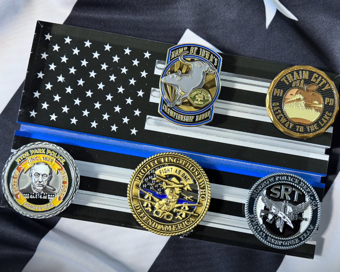 Collection of challenge coins on an American flag with text 'First Challenge Coin - Just $5'.